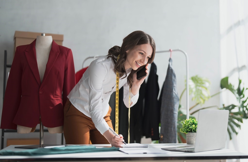 A small business owner working on bookkeeping talking on the phone