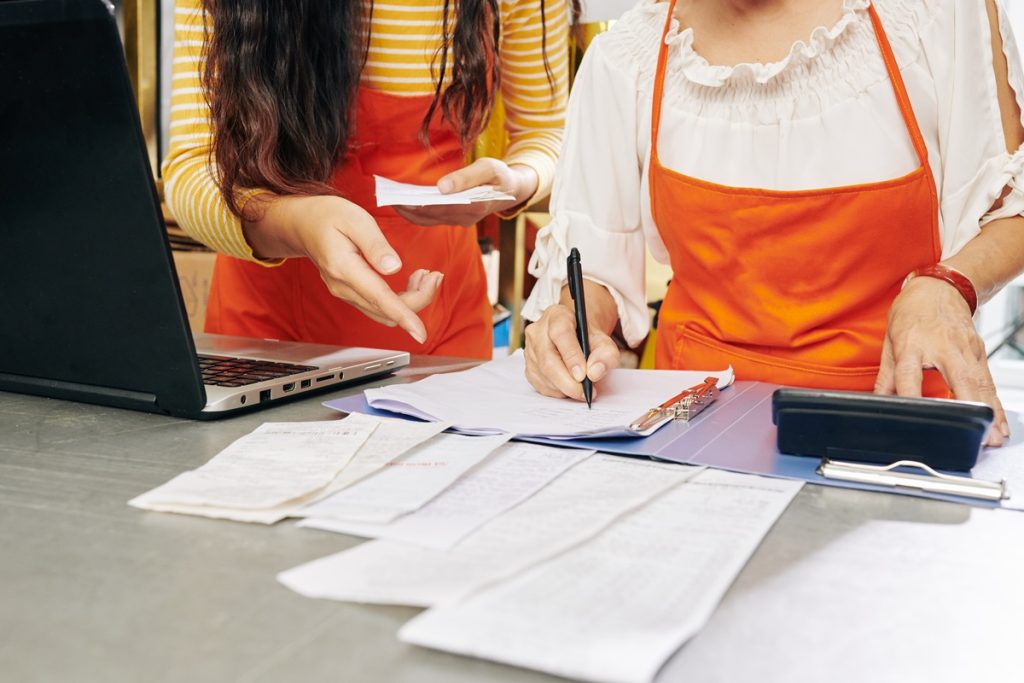 Two workers working on bookkeeping