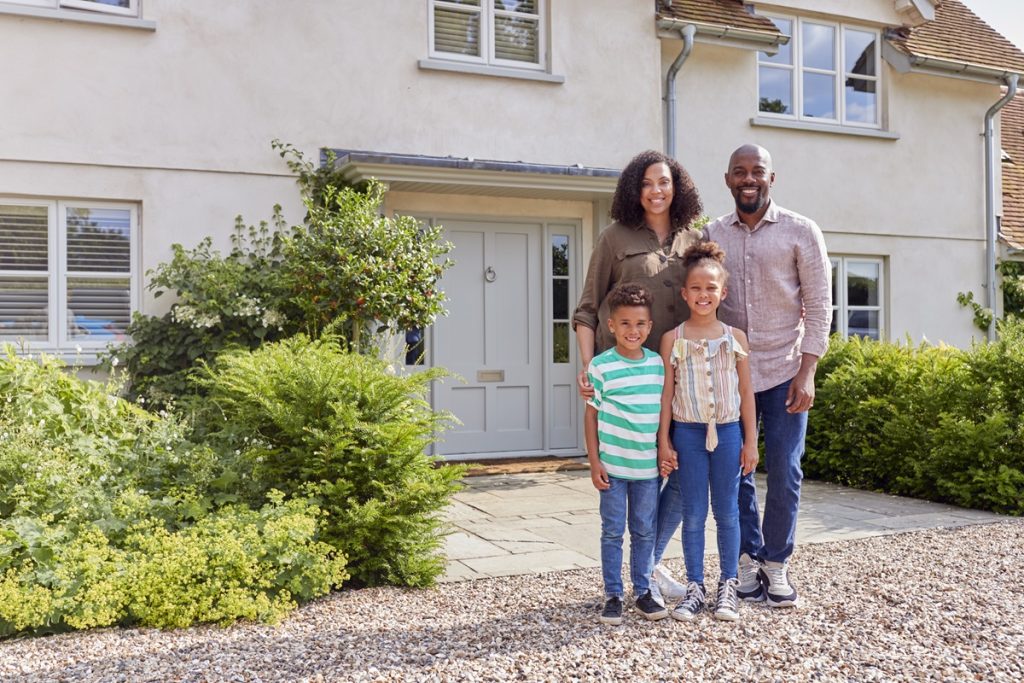 A family standing outside their home