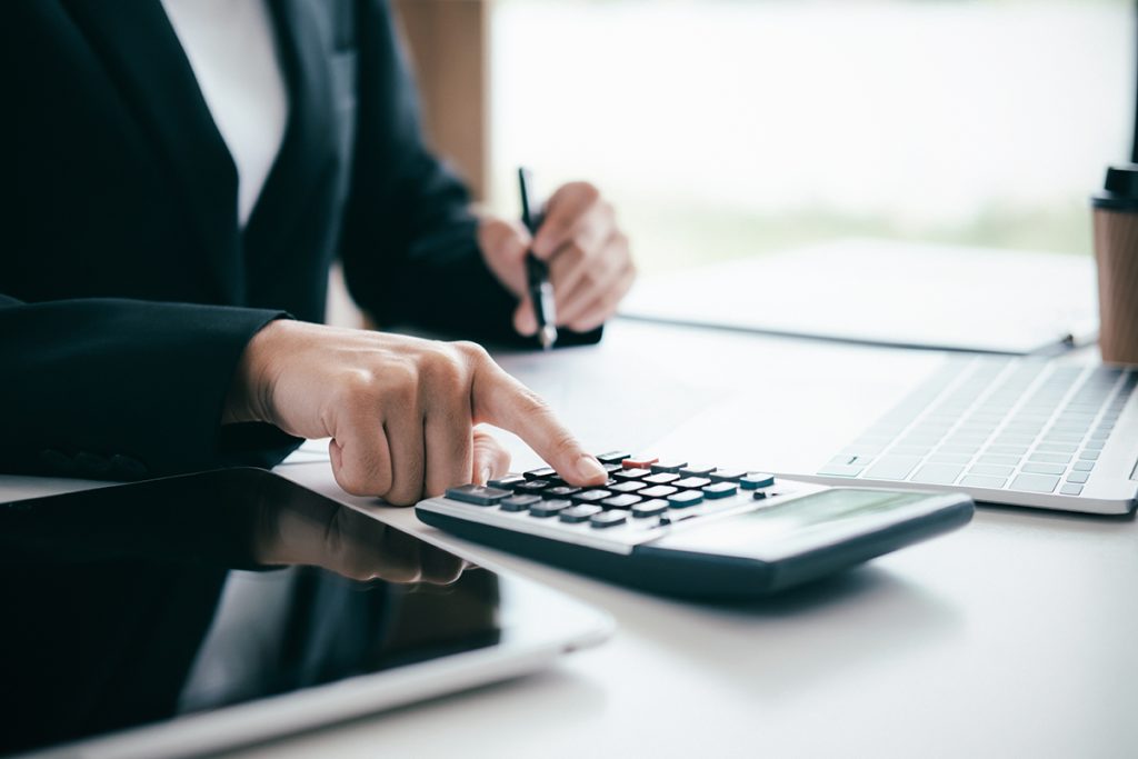 An accountant working on a calculator