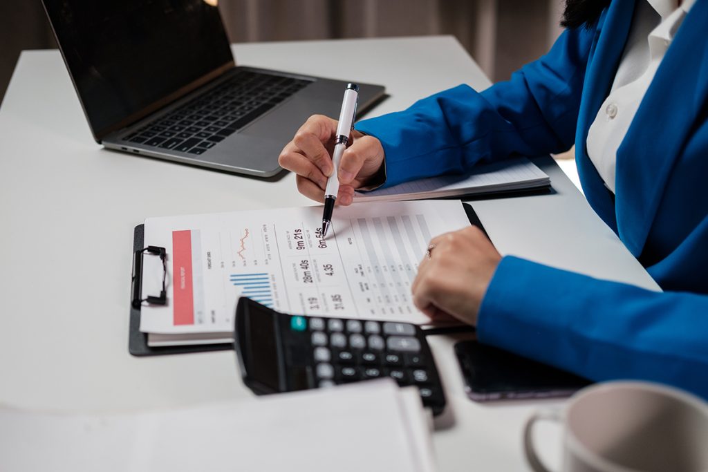 A professional working on some documents with a calculator