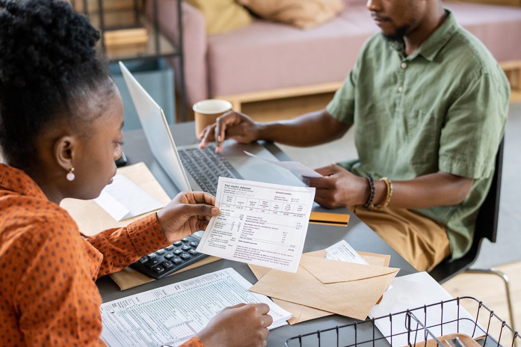 Two colleagues working on documents in an office