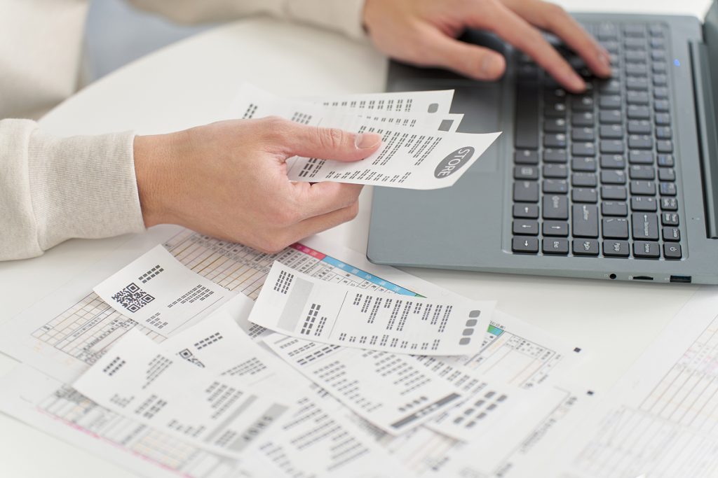 An accountant recording numbers in different receipts