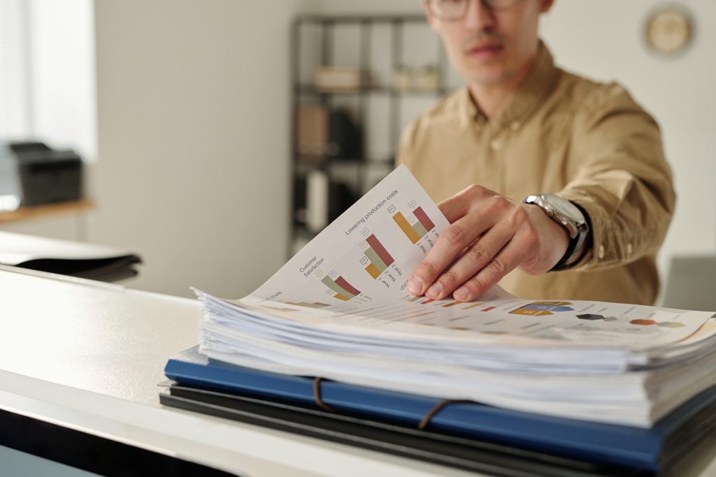 male accountant looking over some graphs