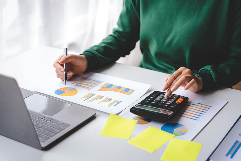 An accountant making calculations of some graph data