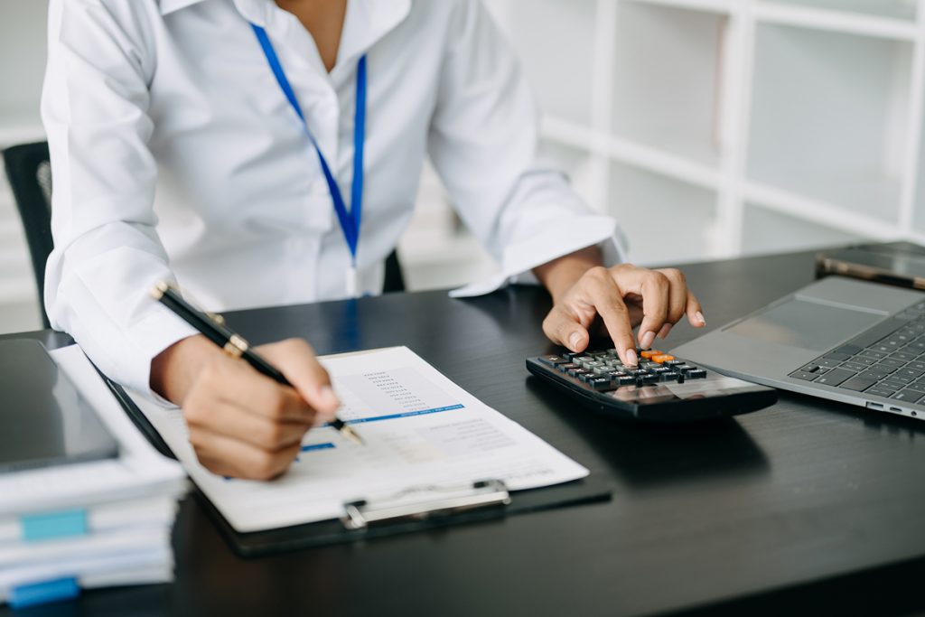 An account working on some calculations at the office